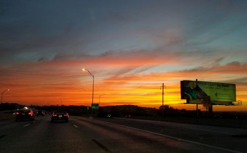Cars on road at sunset