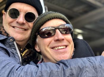 Portrait of smiling men wearing sunglasses