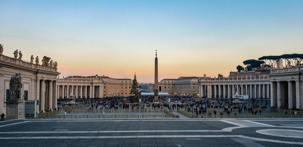 Buildings in city at sunset