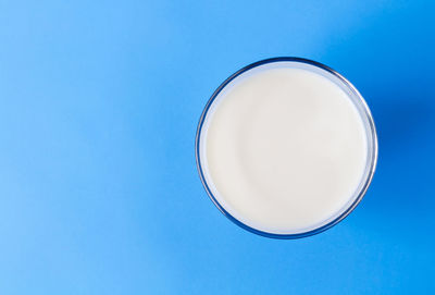 Low angle view of drink against blue sky