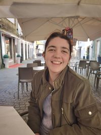 Portrait of young woman sitting at restaurant