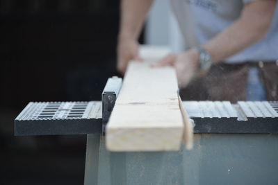 Close-up of man playing with text on table