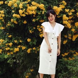 Full length of woman standing on yellow flowering plants