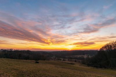 Scenic view of field against sky during sunset