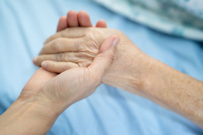 Cropped image of people holding hands