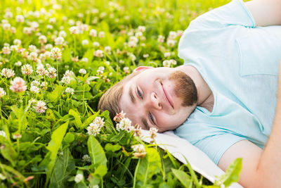 Portrait of man lying down against plants
