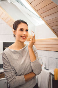 Portrait of young woman using mobile phone