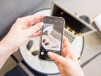 Midsection of man using mobile phone