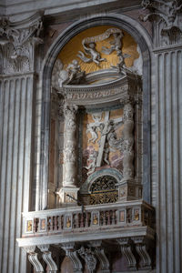 Low angle view of statue against historic building