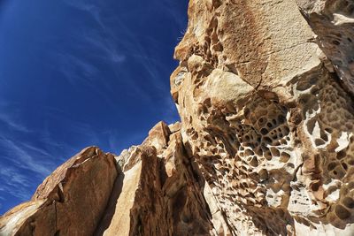 Low angle view of rock formation against sky