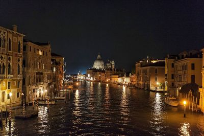 View of canal in city at night