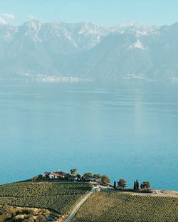 Scenic view of sea and mountains against sky