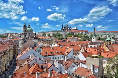 High angle view of buildings and prague castle against blue sky