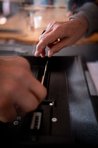 Cropped hands of man using sound mixer