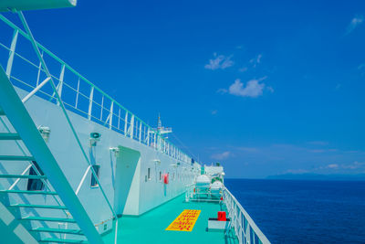 Low angle view of ship on sea against blue sky