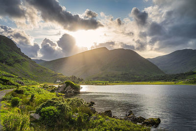 Scenic view of lake and mountains against sky