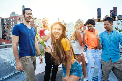 Happy friends on building terrace