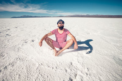 Full length of man on sand at beach against sky