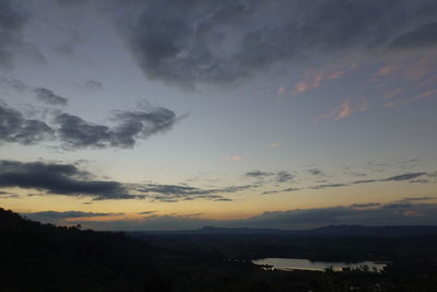 Scenic view of dramatic sky over silhouette landscape