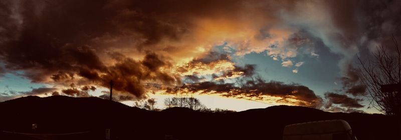 Silhouette landscape against dramatic sky