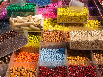 High angle view of colorful beads in containers at store