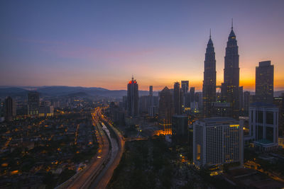 High angle view of city lit up at night