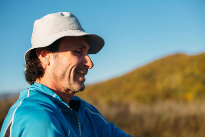 Portrait of man wearing hat against sky