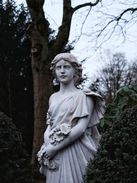 Low angle view of statue against trees