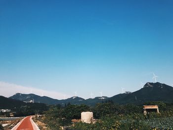 Scenic view of mountains against blue sky