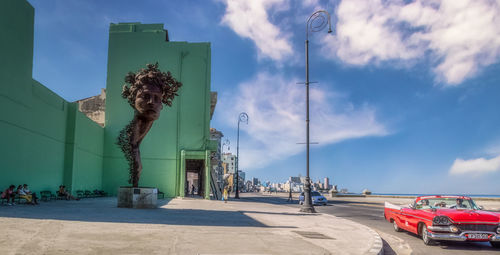 Panoramic view of city street against sky