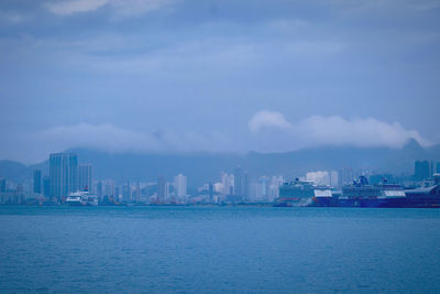 Panoramic view of sea and buildings against sky