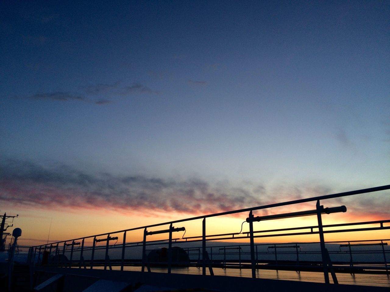 sunset, silhouette, orange color, sky, connection, railing, built structure, low angle view, scenics, beauty in nature, dusk, tranquility, cloud - sky, nature, architecture, bridge - man made structure, tranquil scene, copy space, blue, outdoors