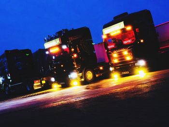 Illuminated working on road against sky at night