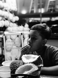 Side view of young woman having food