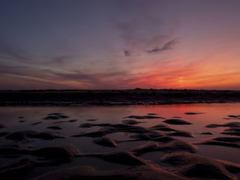 Scenic view of beach against sky during sunset