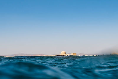 Scenic view of sea against clear blue sky