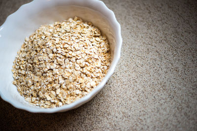 Close-up of oat flakes in bowl on table