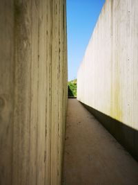 View of wooden walkway against clear sky