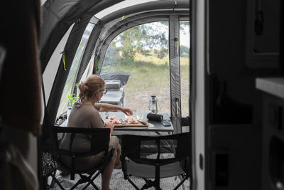 Woman preparing meal in camper van