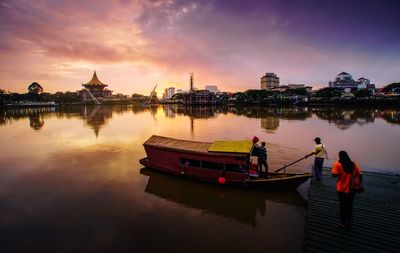 Boats in temple against sky during sunset