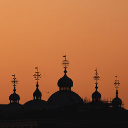 Silhouette temple against sky during sunset