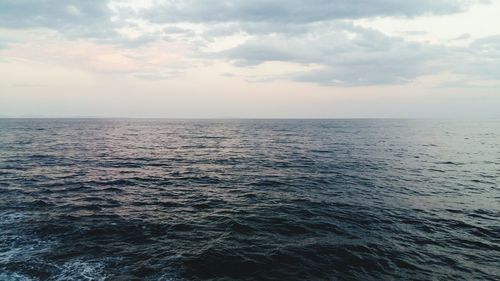 Scenic view of sea against cloudy sky