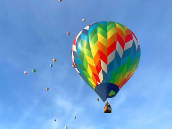 Low angle view of hot air balloons against sky