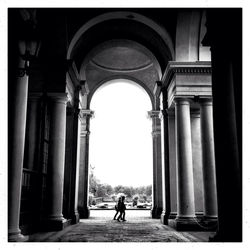 People in front of columns