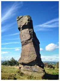 Stack rock on field against sky