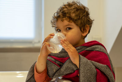 Portrait of boy drinking coffee