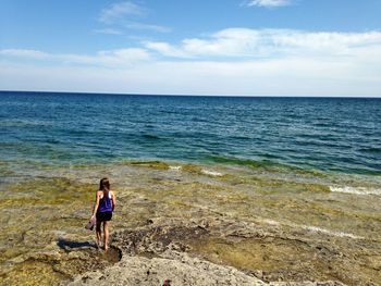 Rear view of girl standing on beach