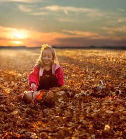 Portrait of smiling girl on field during autumn