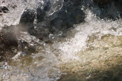 Full frame shot of water flowing through rocks