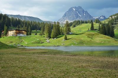 Scenic view of landscape against sky by the alpine lake hotel